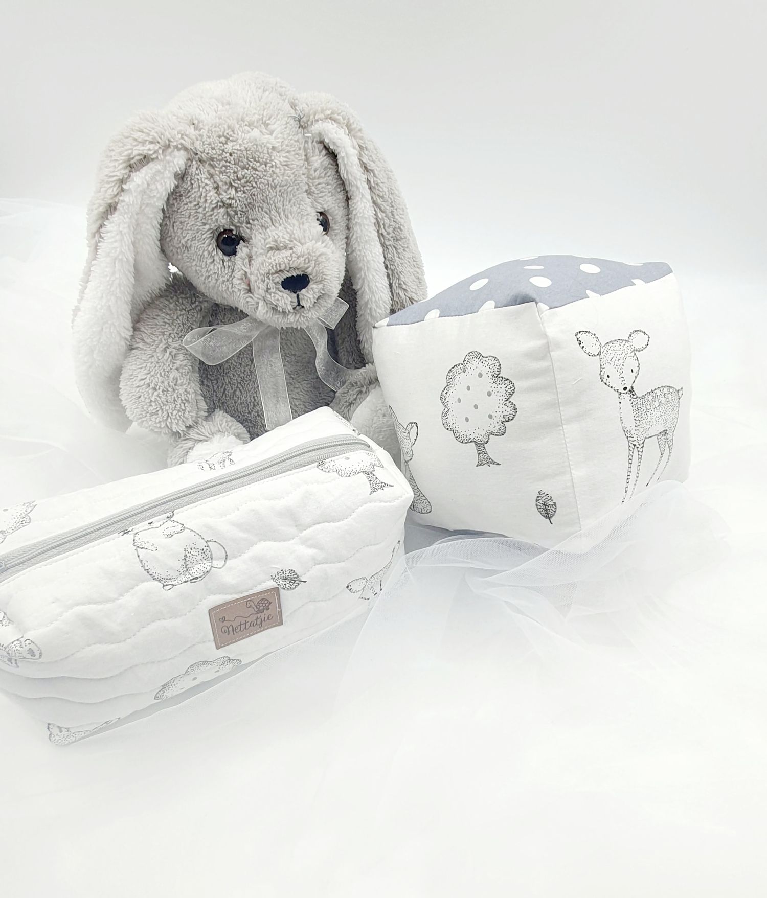 Gray bunny plush toy with white and gray baby accessories featuring animal prints.