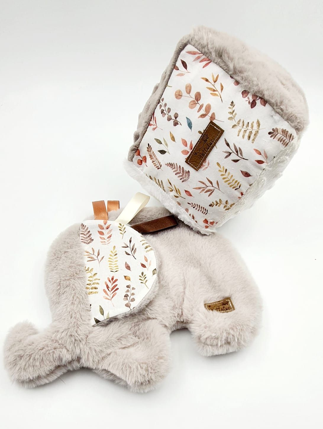 Beige baby blankets with delicate leaf patterns and plush minky fabric shown from different angles.