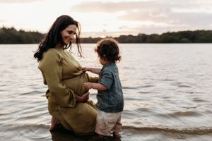 natural family photo of a pregnant mum and her son during a lifestyle family photoshoot in Shrewsbury by India Foxx photographer.