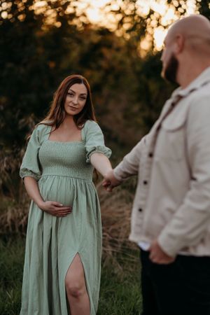 a happy couple outdoors in Shrewsbury at sunset celebrating becoming parents - photo shot by India foxx photography.