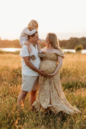 candid family portrait in a golden field at sunset during a relaxed and natural family photoshoot by India Foxx photography.