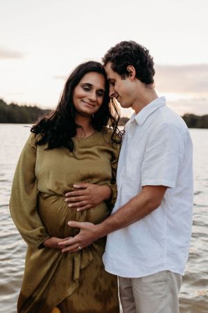 parents to be having a natural maternity photoshoot at the lake in Shrewsbury shot by India Foxx Photography, a natural family photographer