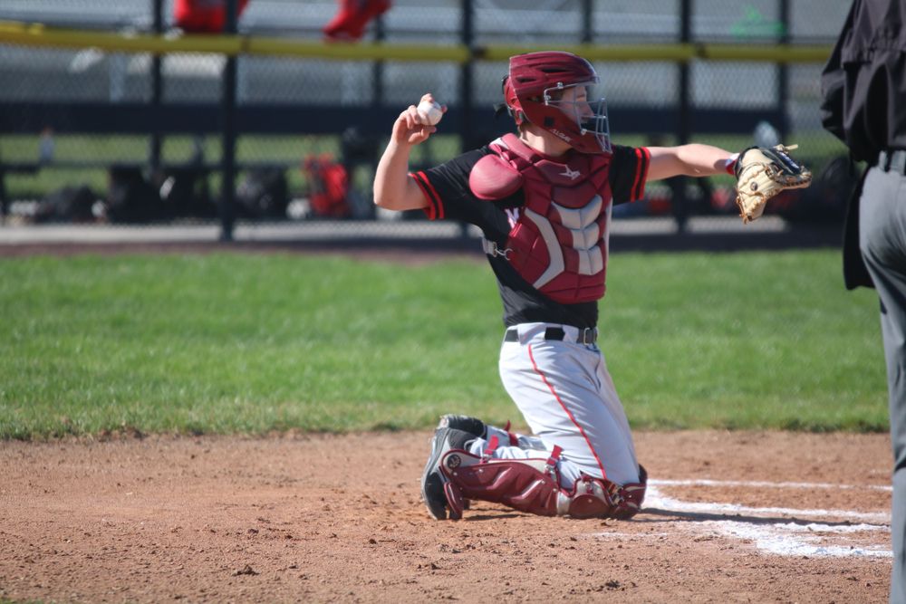 Baseball game sequence showing player in red uniform sliding to base.