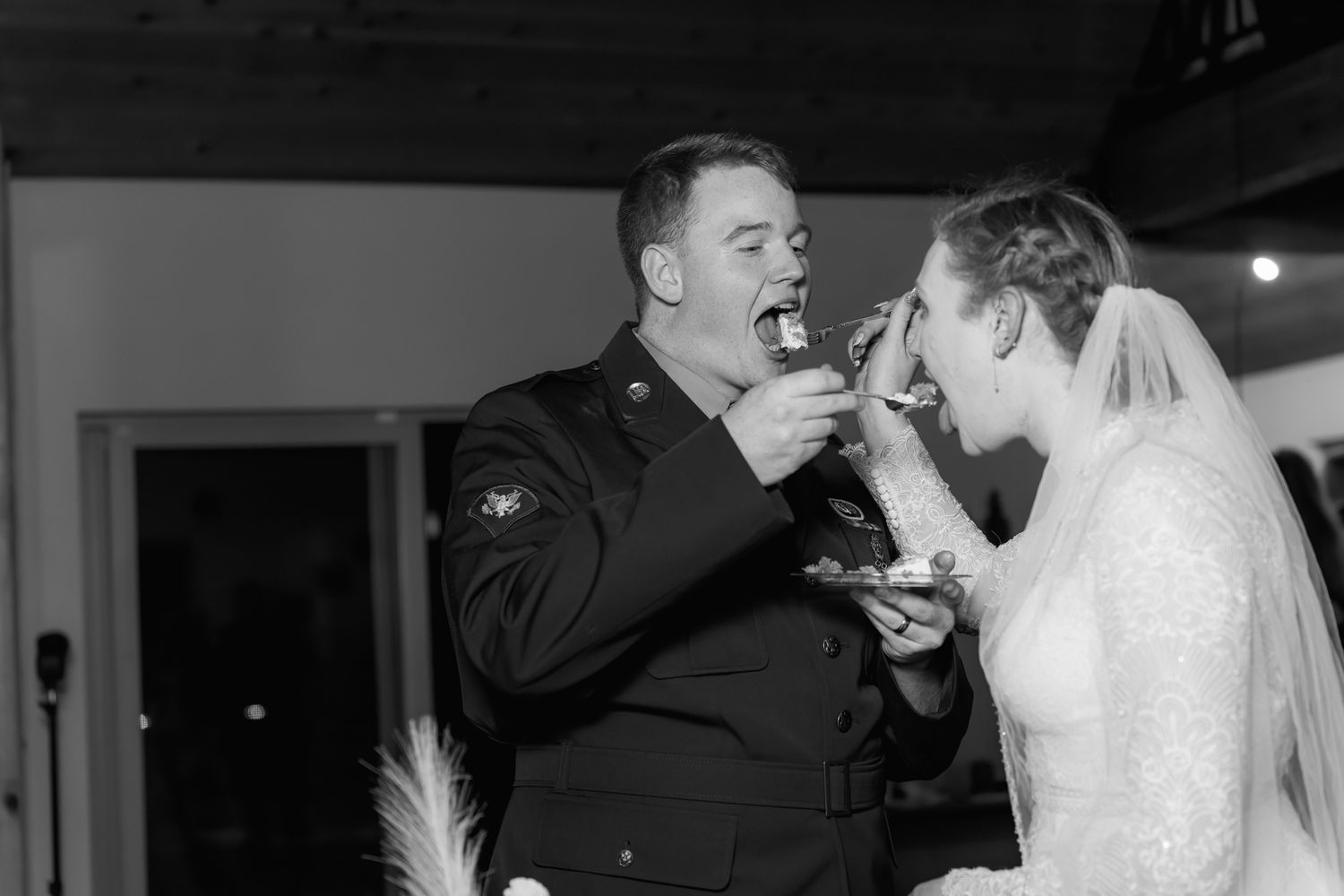 bride and groom feed each other cake