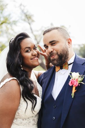 Playful outdoor wedding portraits showing couple's natural chemistry and joy.