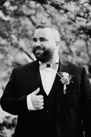 Black and white series of groom portraits showing genuine emotion and laughter.