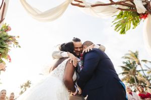 Wedding celebration candid moments showing hugs and embraces.