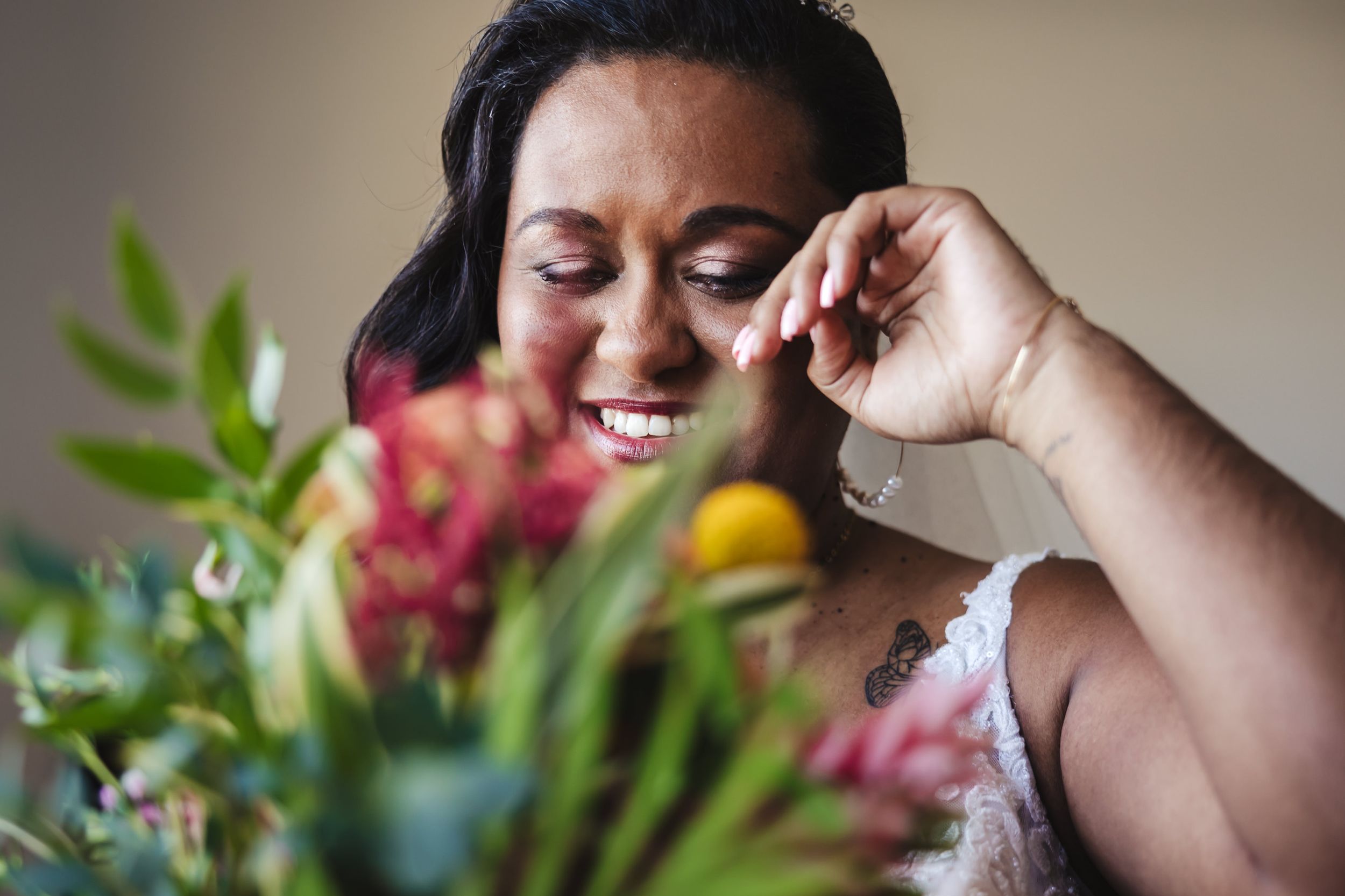 Wedding preparation scene with floral arrangements and greenery.
