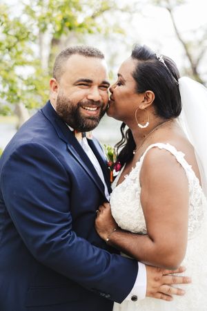 Intimate wedding couple portraits showing joyful laughter and embraces outdoors.