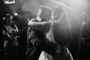 Dancing and celebrating at a dimly lit wedding reception.