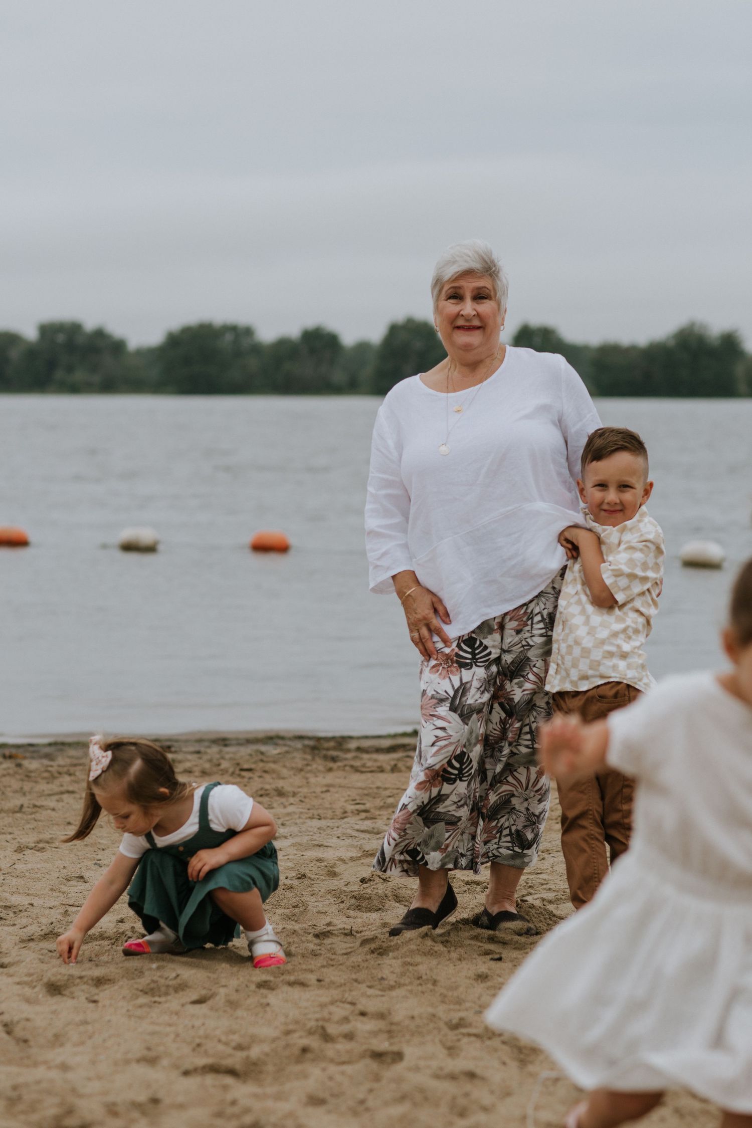 Fun beach day activities with children playing in the sand near the water.