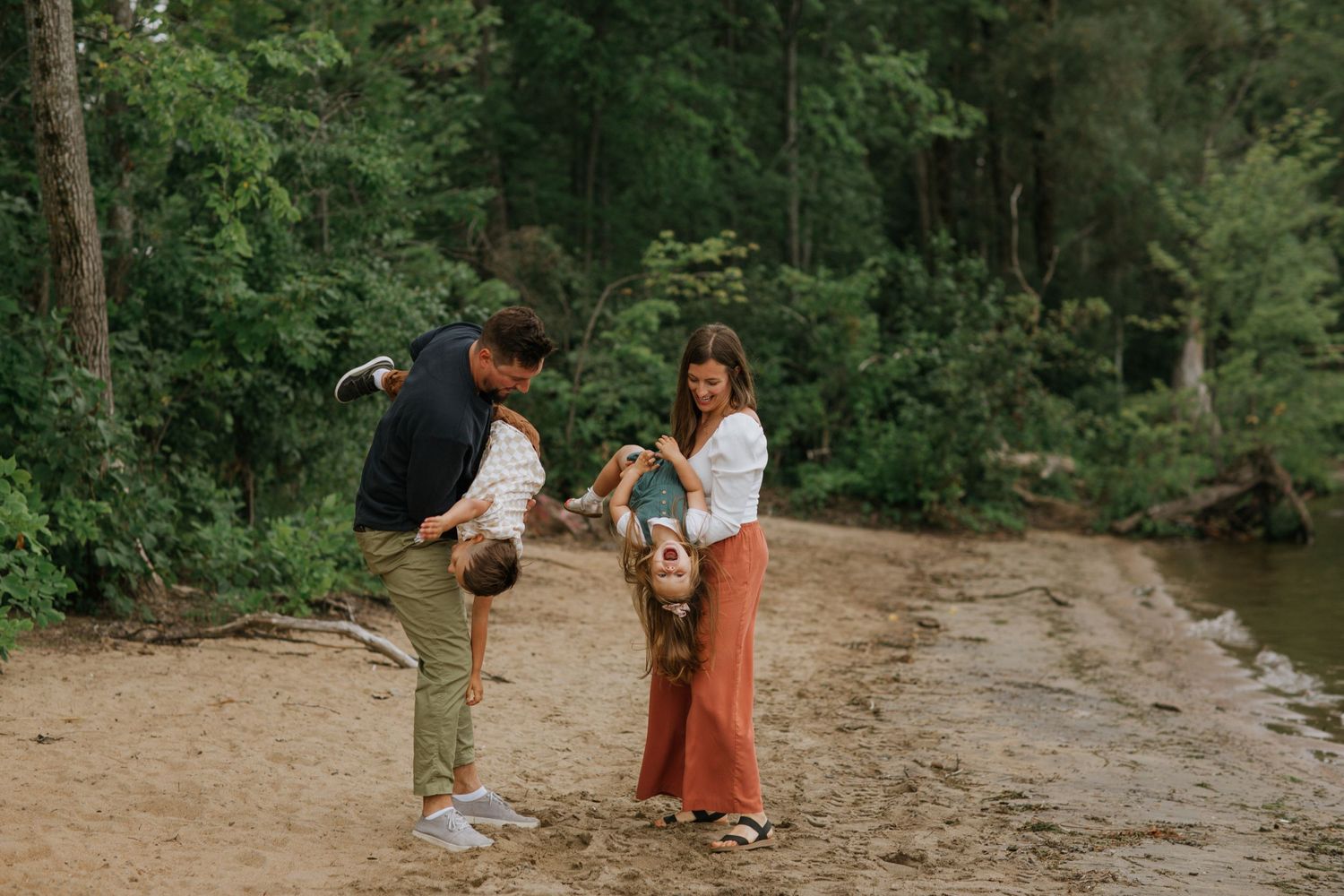 A sweet outdoor moment shared between adults and baby on a nature path.