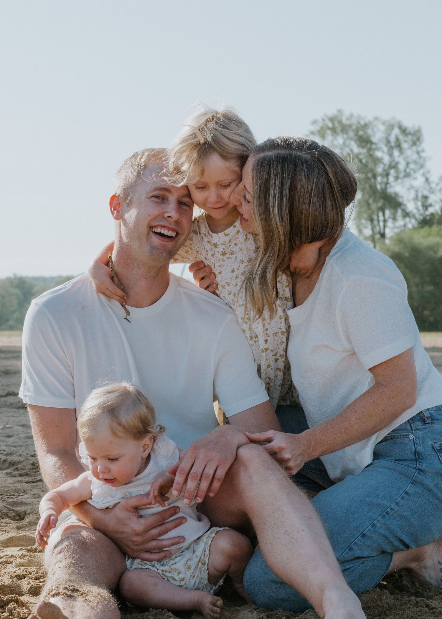 Candid family portraits showing joyful moments together on beach.