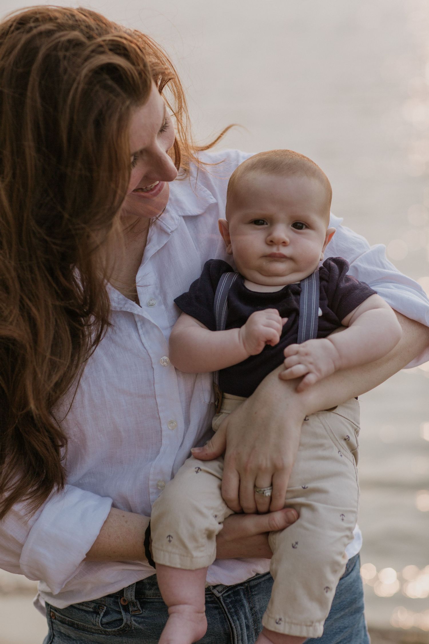 A series of intimate beach portraits showing tender moments with an infant at sunset.