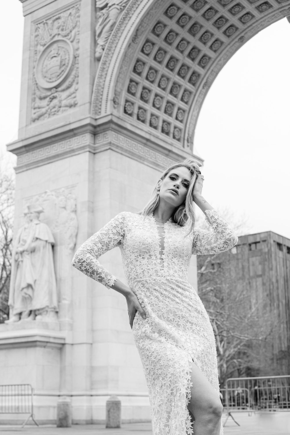 Elegant lace wedding dress photographed in front of Washington Square Arch in New York City.