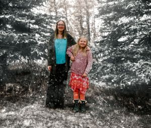 A winter portrait in a snowy evergreen forest with selective color highlighting.
