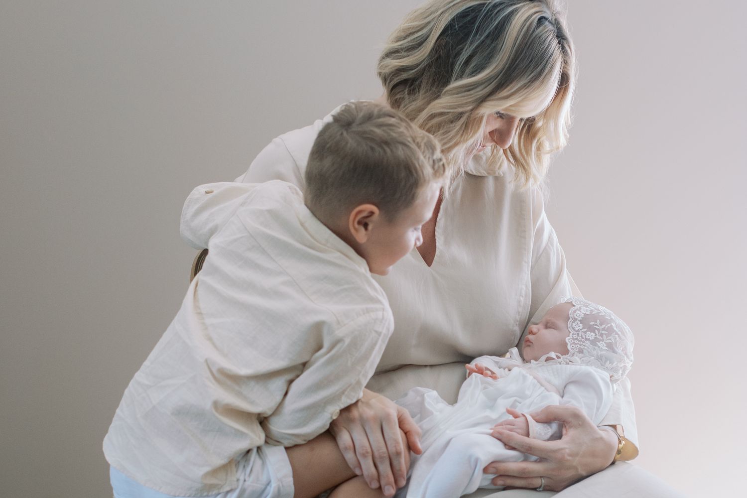 A tender moment between family members as they welcome their newest addition.