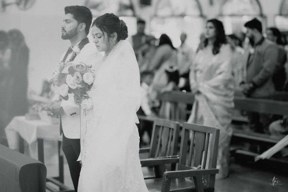 Interior view of church during wedding ceremony with guests seated in pews.
