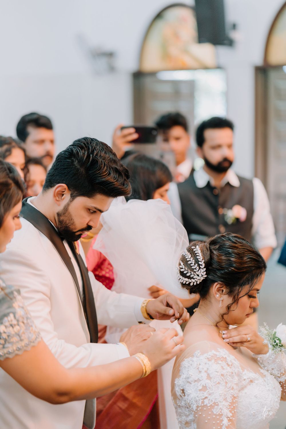 Traditional church wedding ceremony with attendees in formal attire.