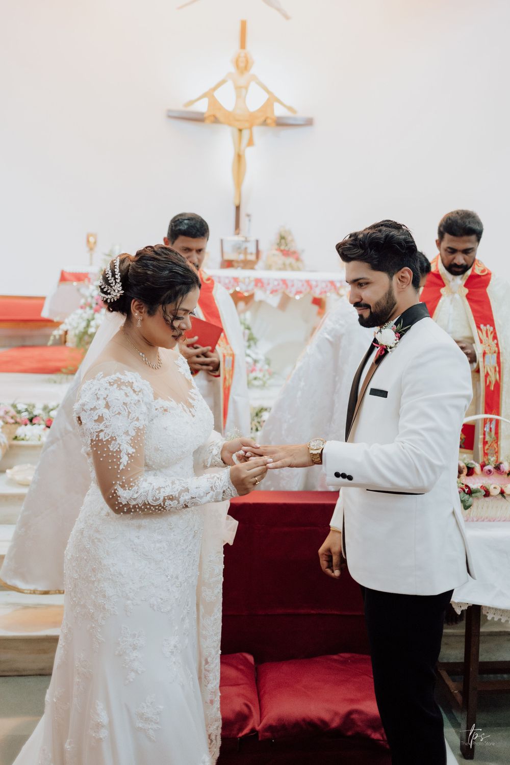 A couple exchanges rings during a traditional church wedding ceremony.