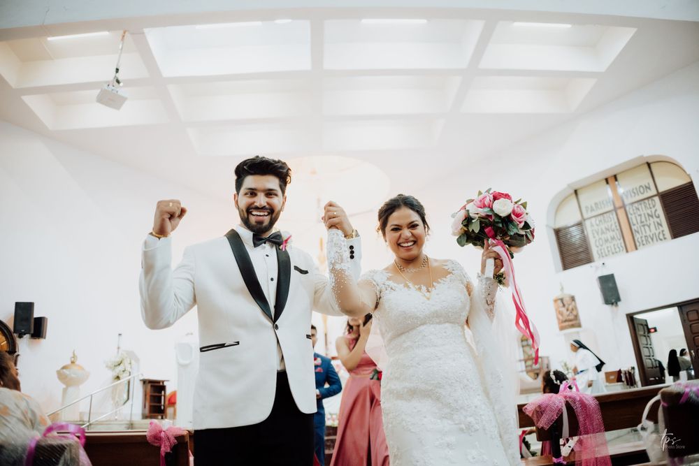 Wedding celebration candid moments captured in church with white and pink decor.