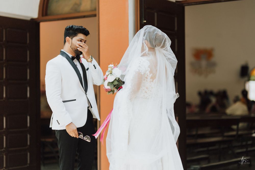 Wedding ceremony in a church with orange walls and geometric window patterns.