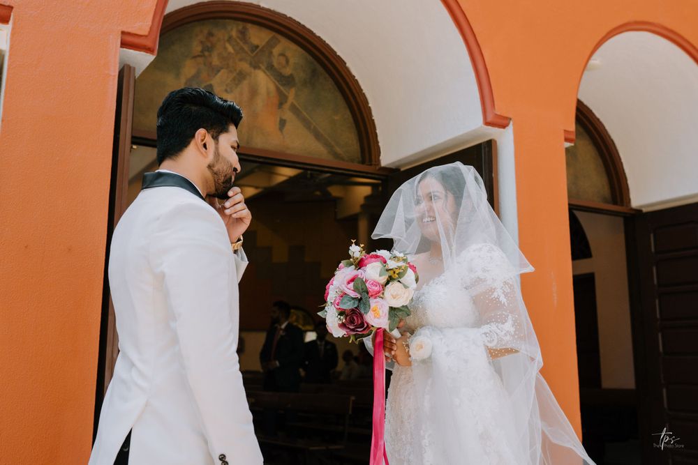 Elegant church interior with orange walls and decorative window designs during a wedding.