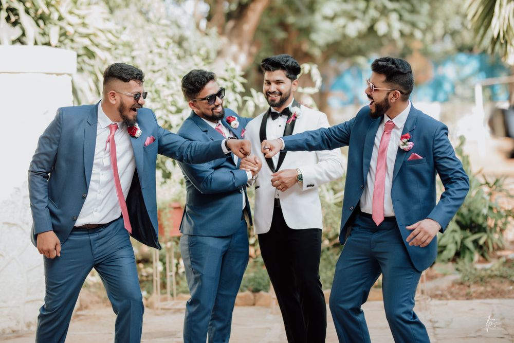 Groomsmen share laughs and candid moments during outdoor wedding photoshoot.