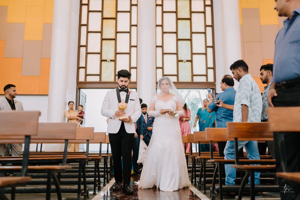 Church interior with orange walls and geometric patterns during wedding ceremony.