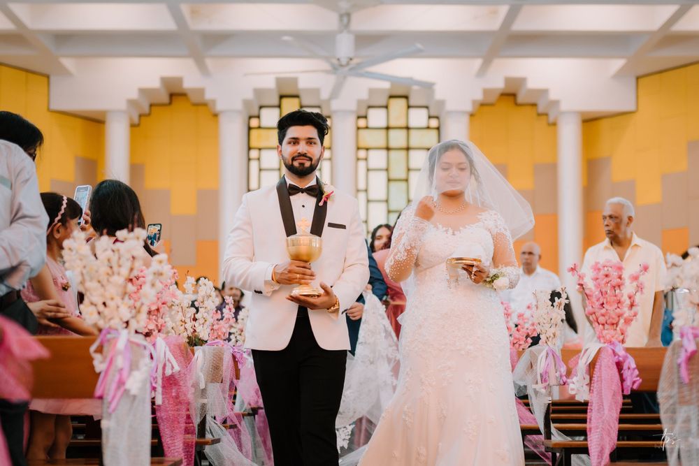 Wedding celebration in a church with yellow walls and ornate architectural details.