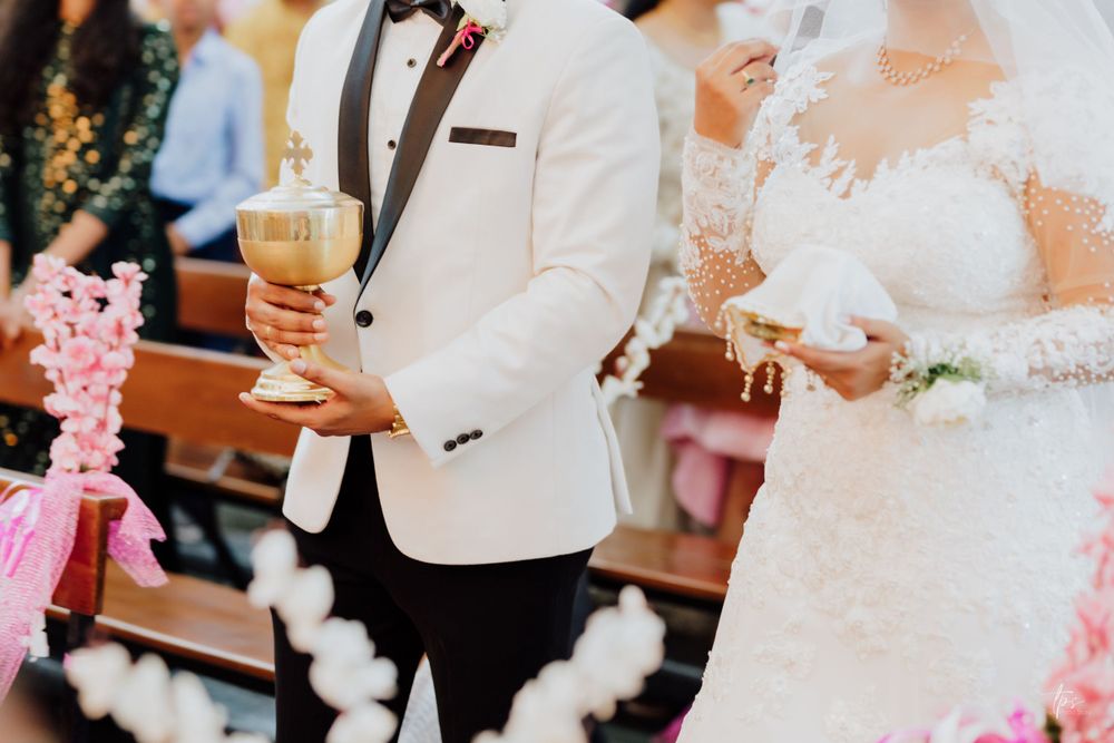 Wedding celebration with pink floral decorations and formal attire.
