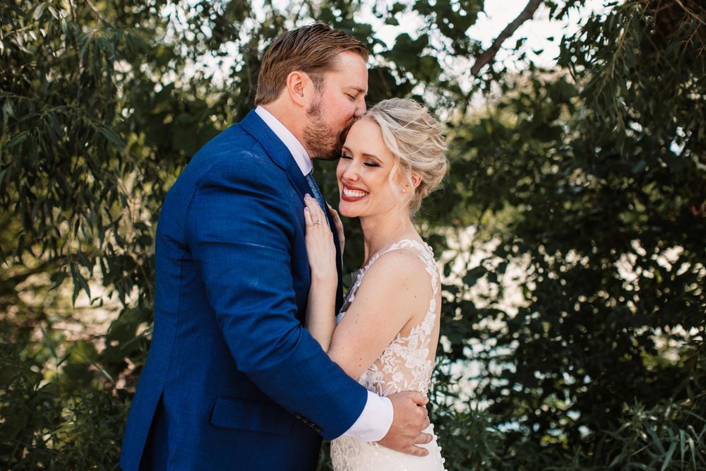Intimate moment between newlyweds during their outdoor wedding photoshoot.