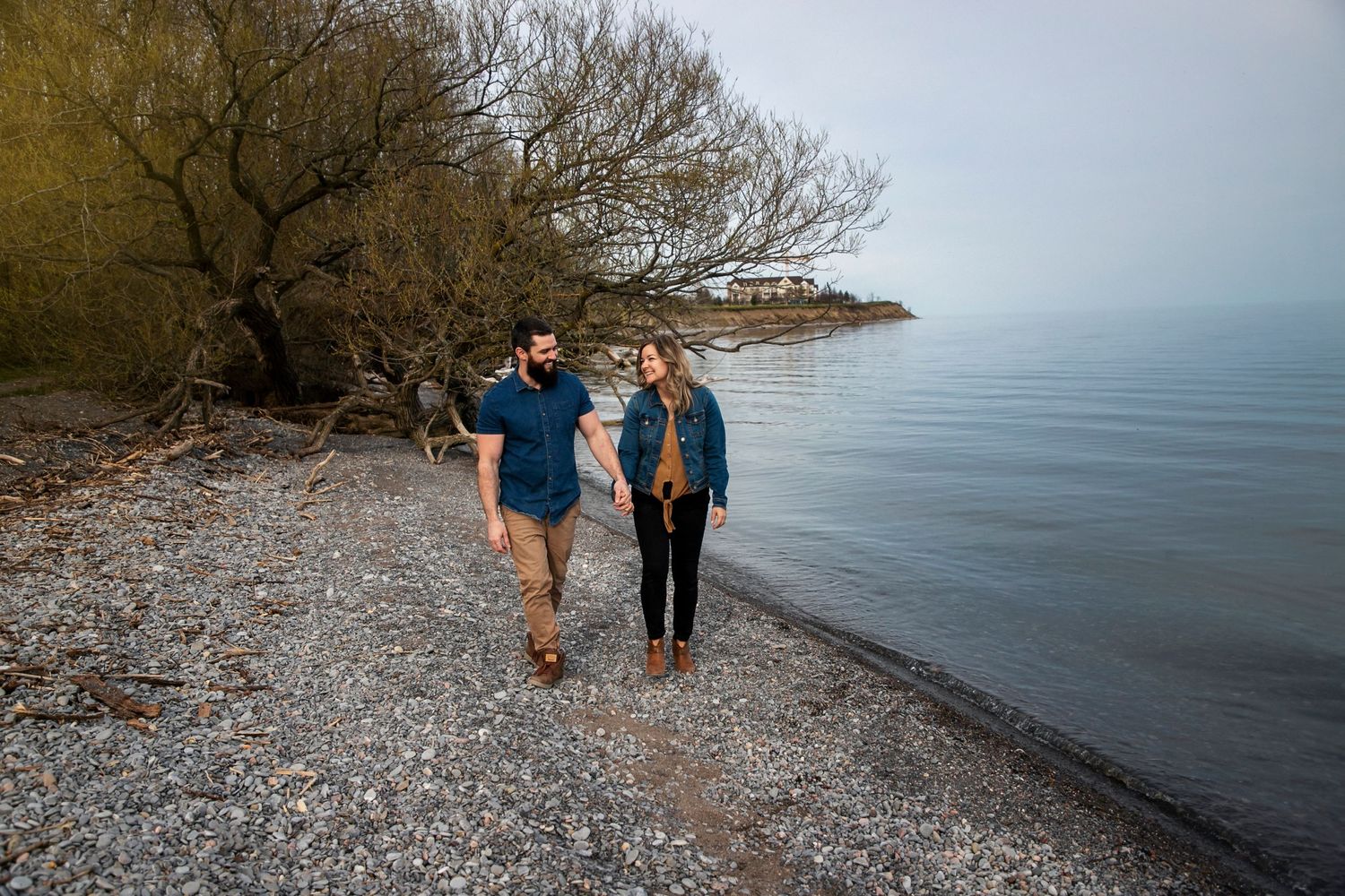 A couple walking on the rocky beach in Newcastle holding hands