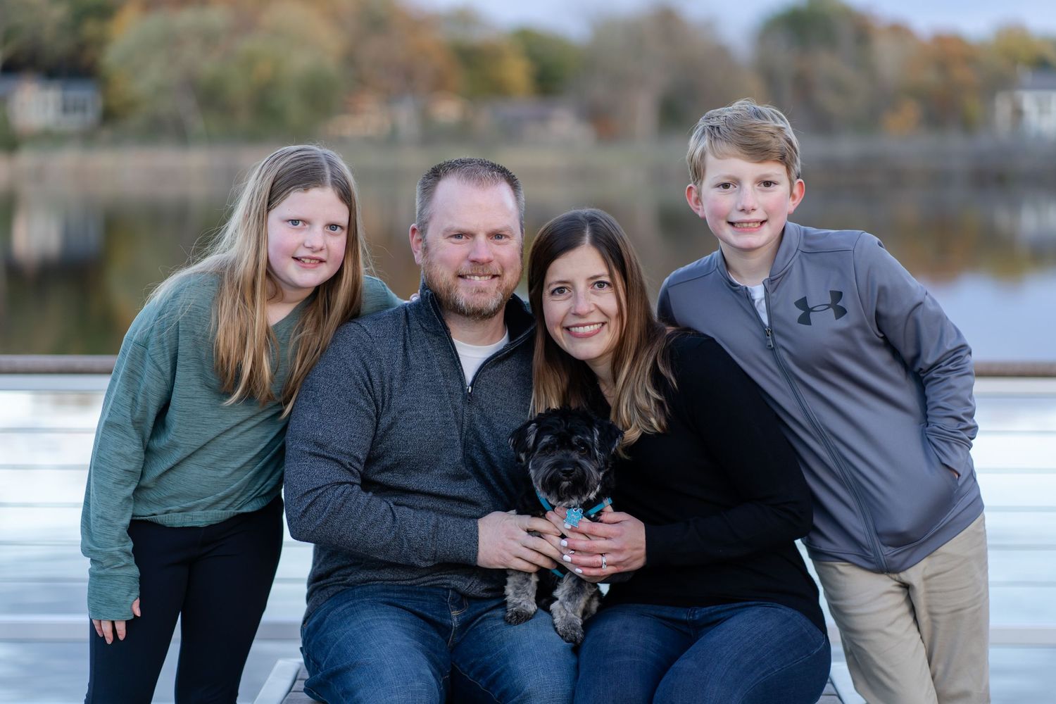 Couple with their kids and dog on the dock at Marshbank Park in West Bloomfield, MI