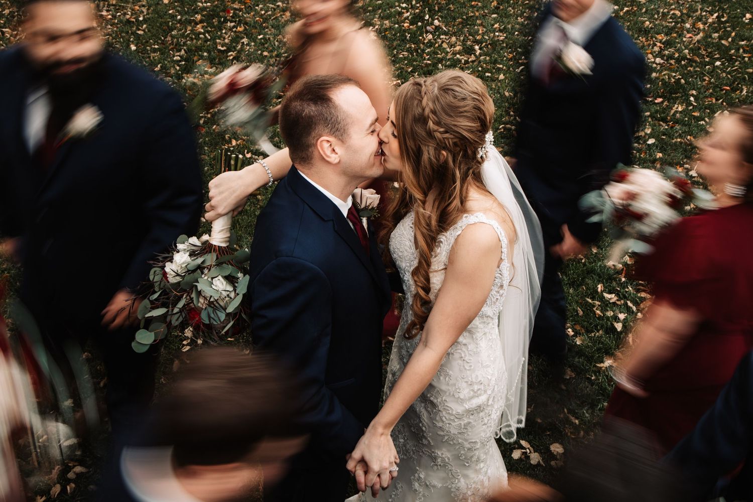 Motion blur captures wedding celebration moment among twinkling lights and guests.