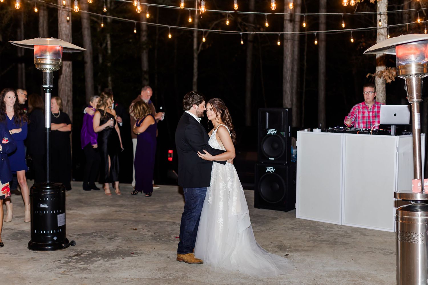 Indoor wedding reception venue with string lights and dark ambiance.
