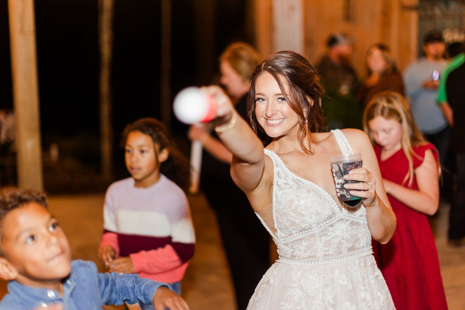 Wedding reception dance party with guests celebrating on the dance floor.