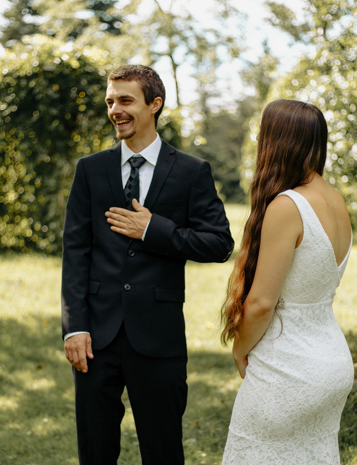 Couple eloping under tree in intimate ceremony.