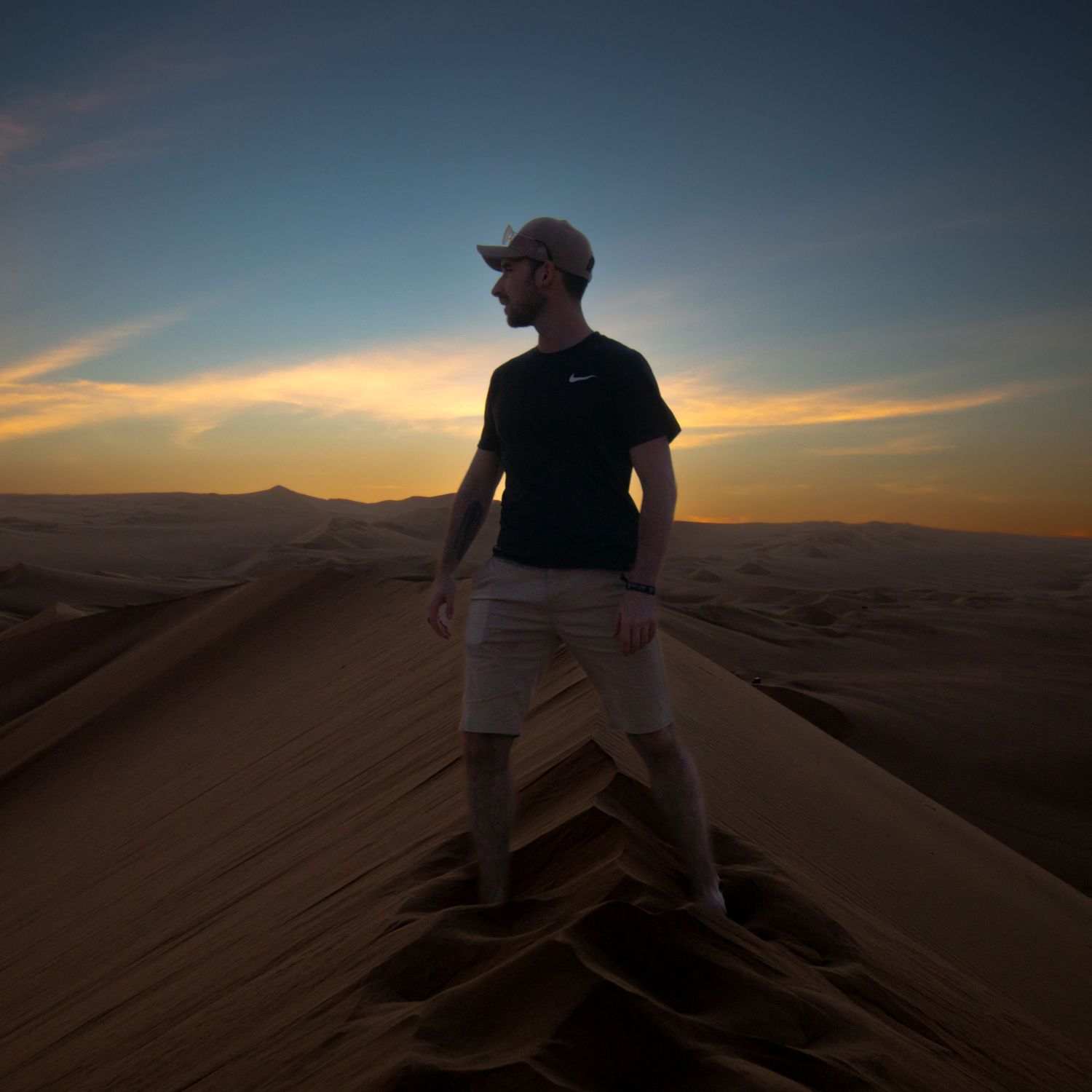 Sunset on a dune top in Huacachina desert, Peru