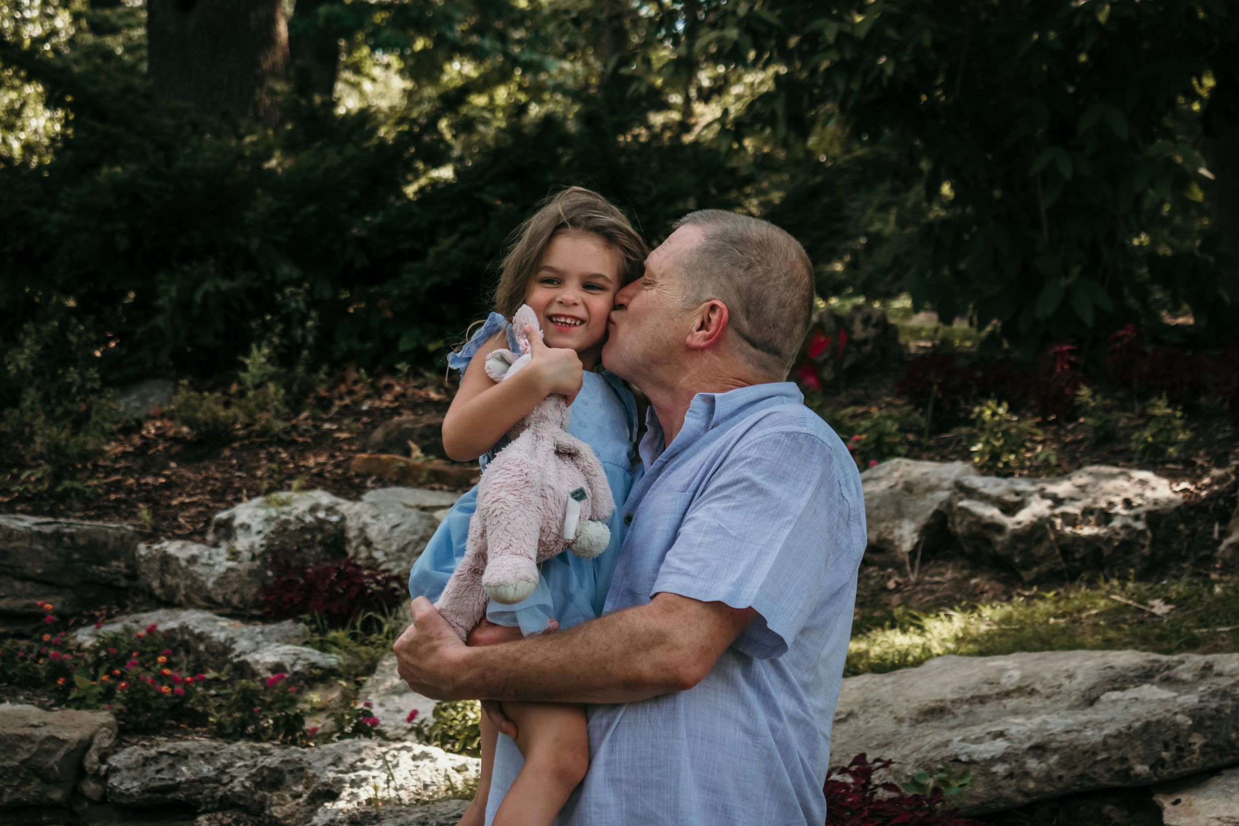 A grandpa has a sweet moment with his granddaughter