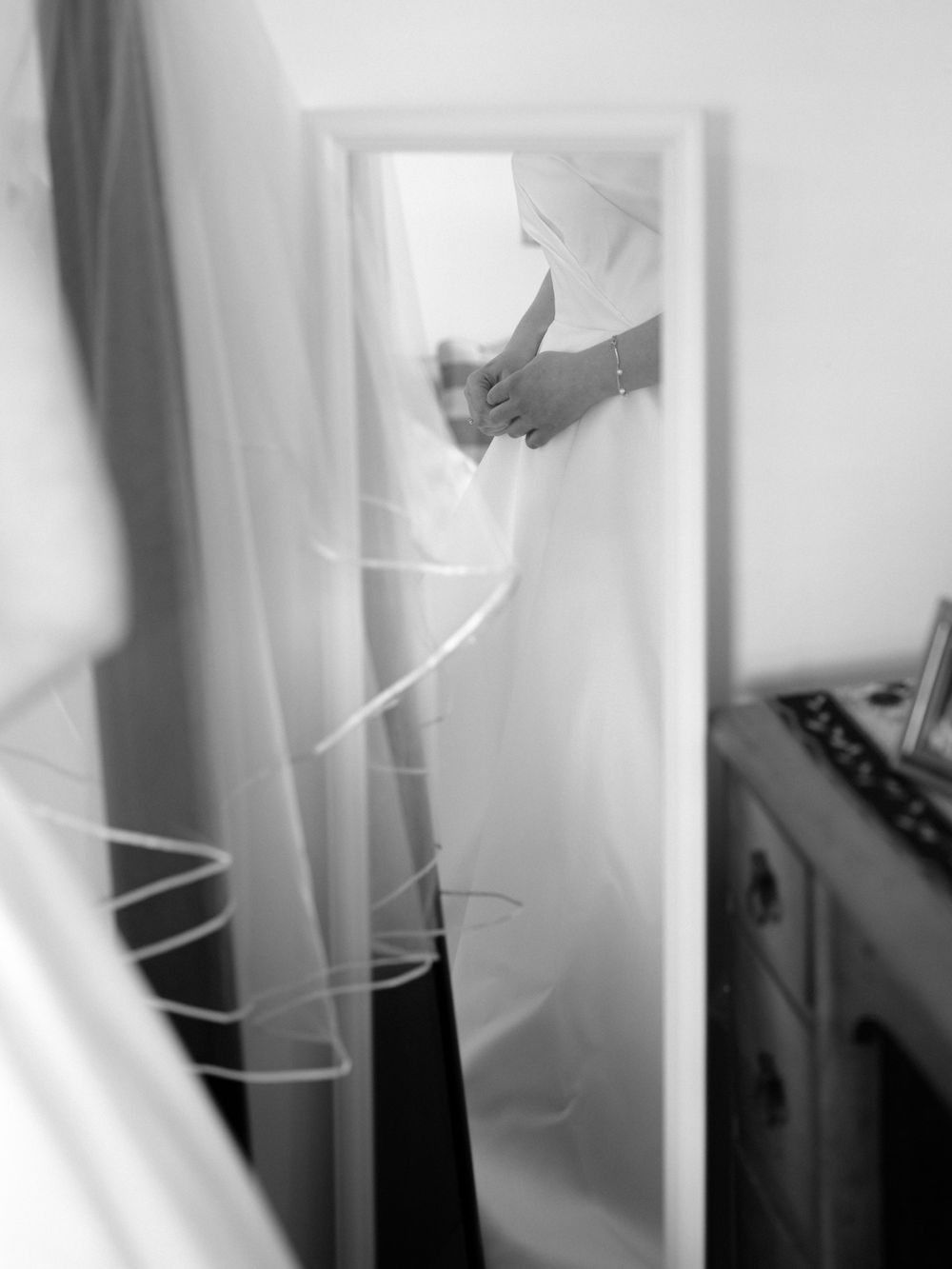 Abstract black and white close-up of flowing wedding dress fabric.