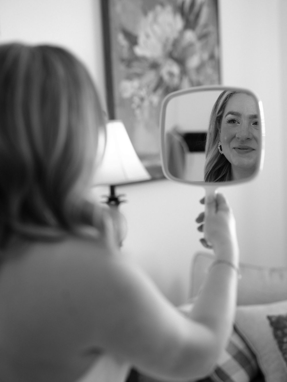 Getting ready scene with mirror reflection and natural lighting.