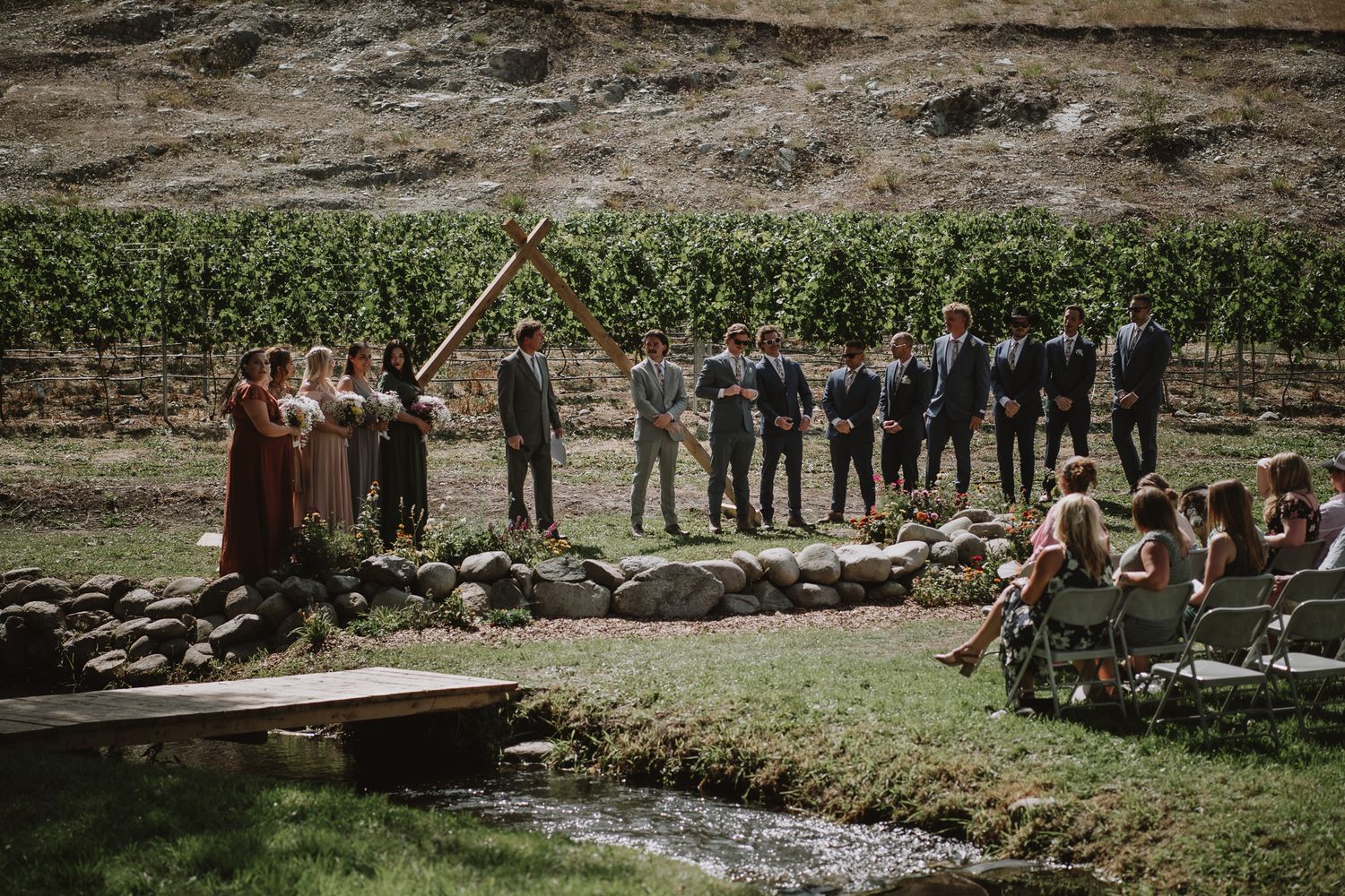 Groom standing at the alter next to the grooms men and bridesmaids waiting for the bride