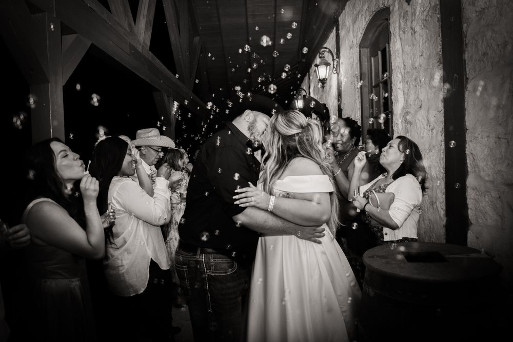 Wedding reception dance captured in dramatic black and white photography.