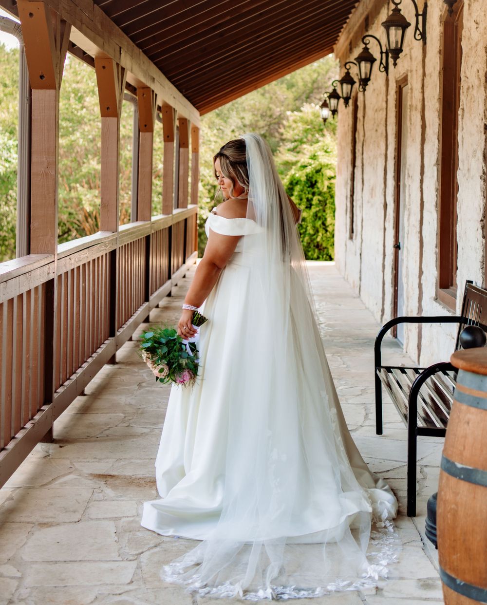 Series of wedding dress photos showing flowing train and details along covered walkway.