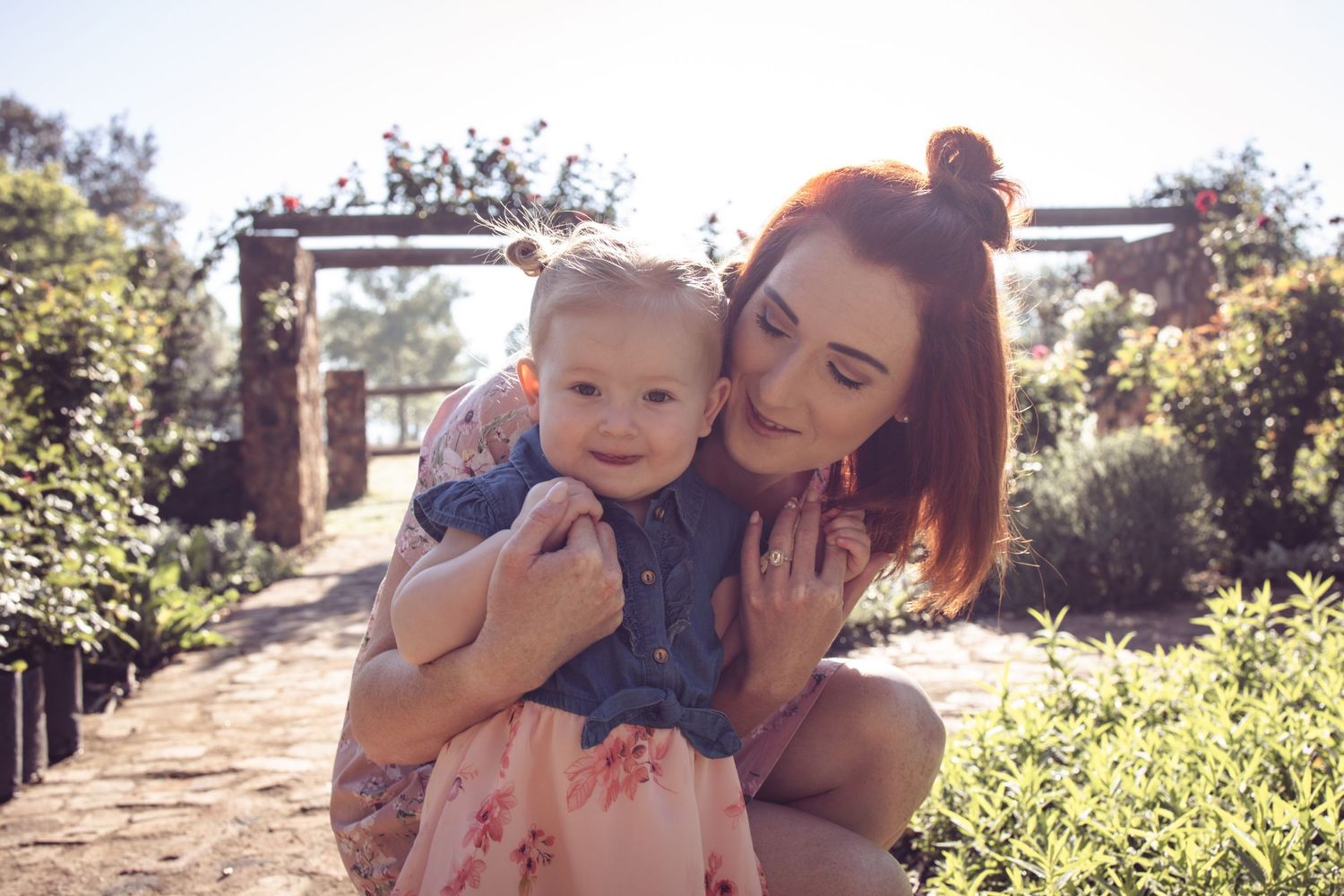 Mother and baby during family portrait session in Centurion with natural, joyful style in outdoor garden setting