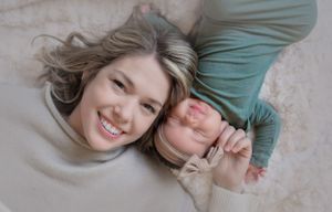 Intimate lifestyle portrait of two people lying down and sharing joyful moment.