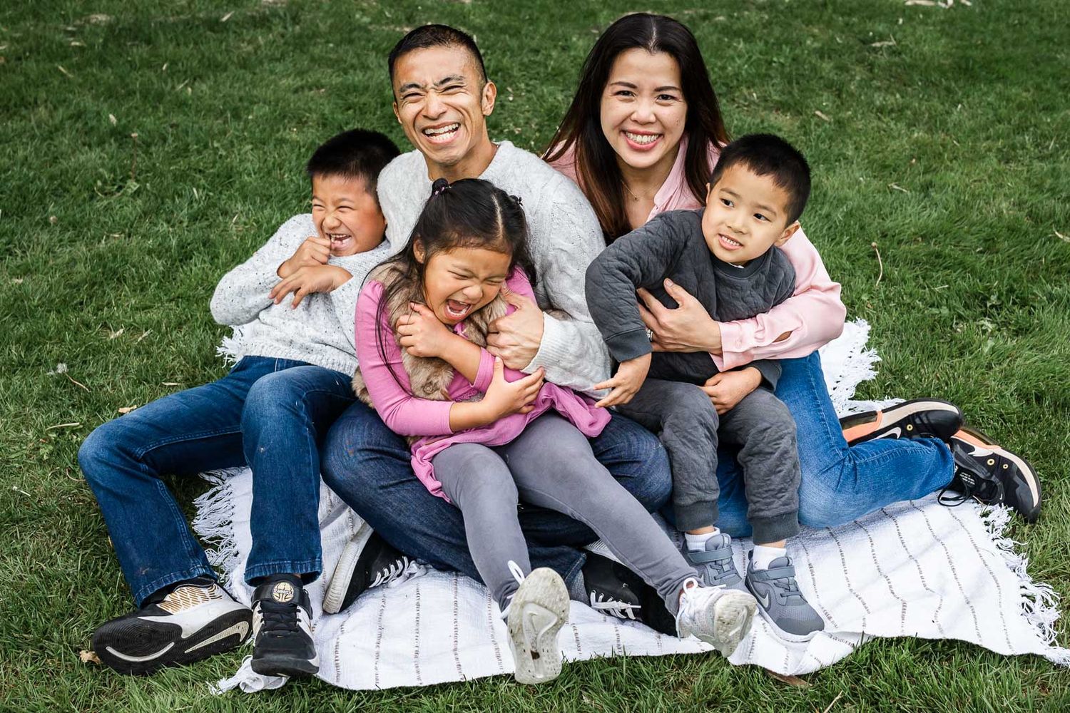 Bellevue family photographer capturing smiling family sitting on a picnic blanket