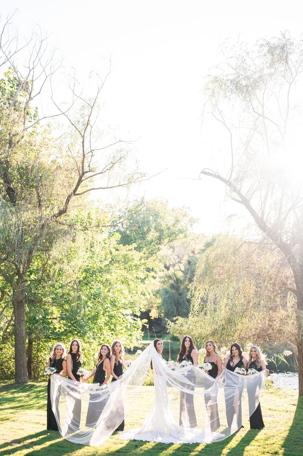 The bride and her bridesmaids playing with the long veil of the bride.