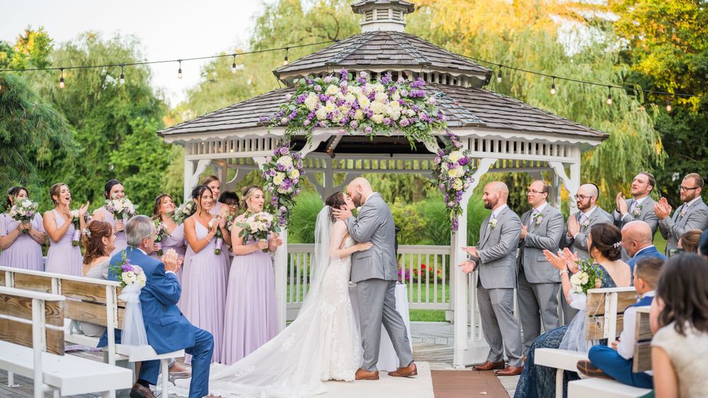 Newlyweds sharing their first kiss as a married couple at the end of the ceremony. Flowerfield Celebrations
